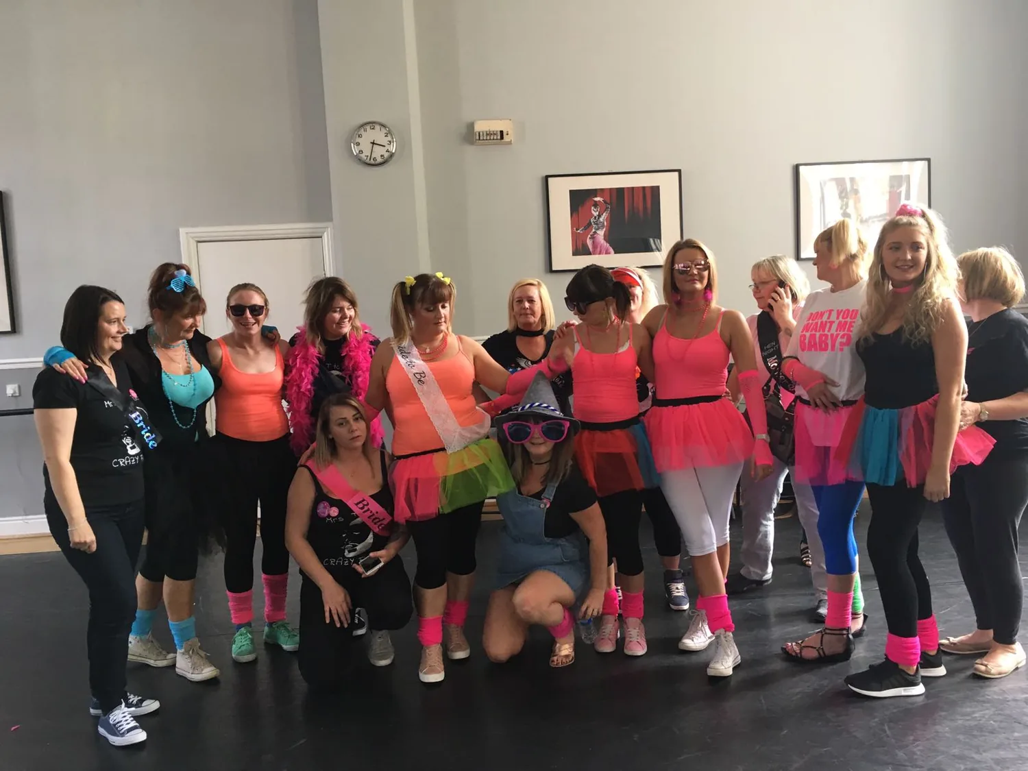 Big hen party group in neon tutus and sashes at their dance class in Plymouth